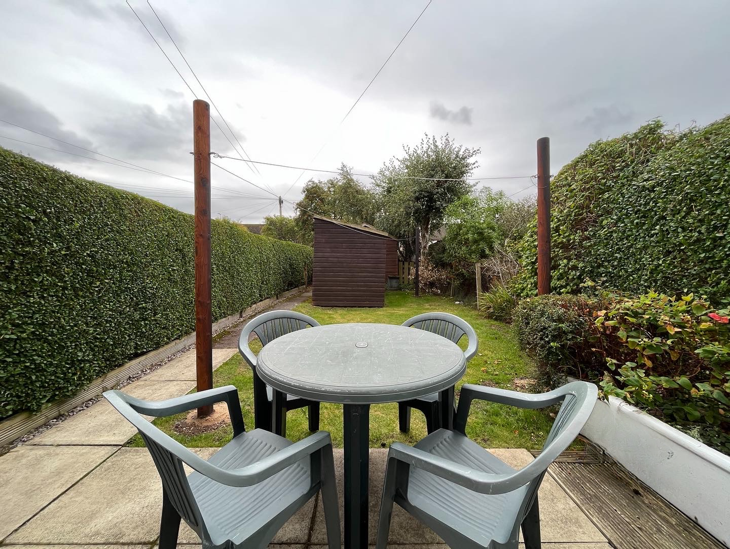 Private rear garden at Inverness Let holiday home — lawn, patio seating area