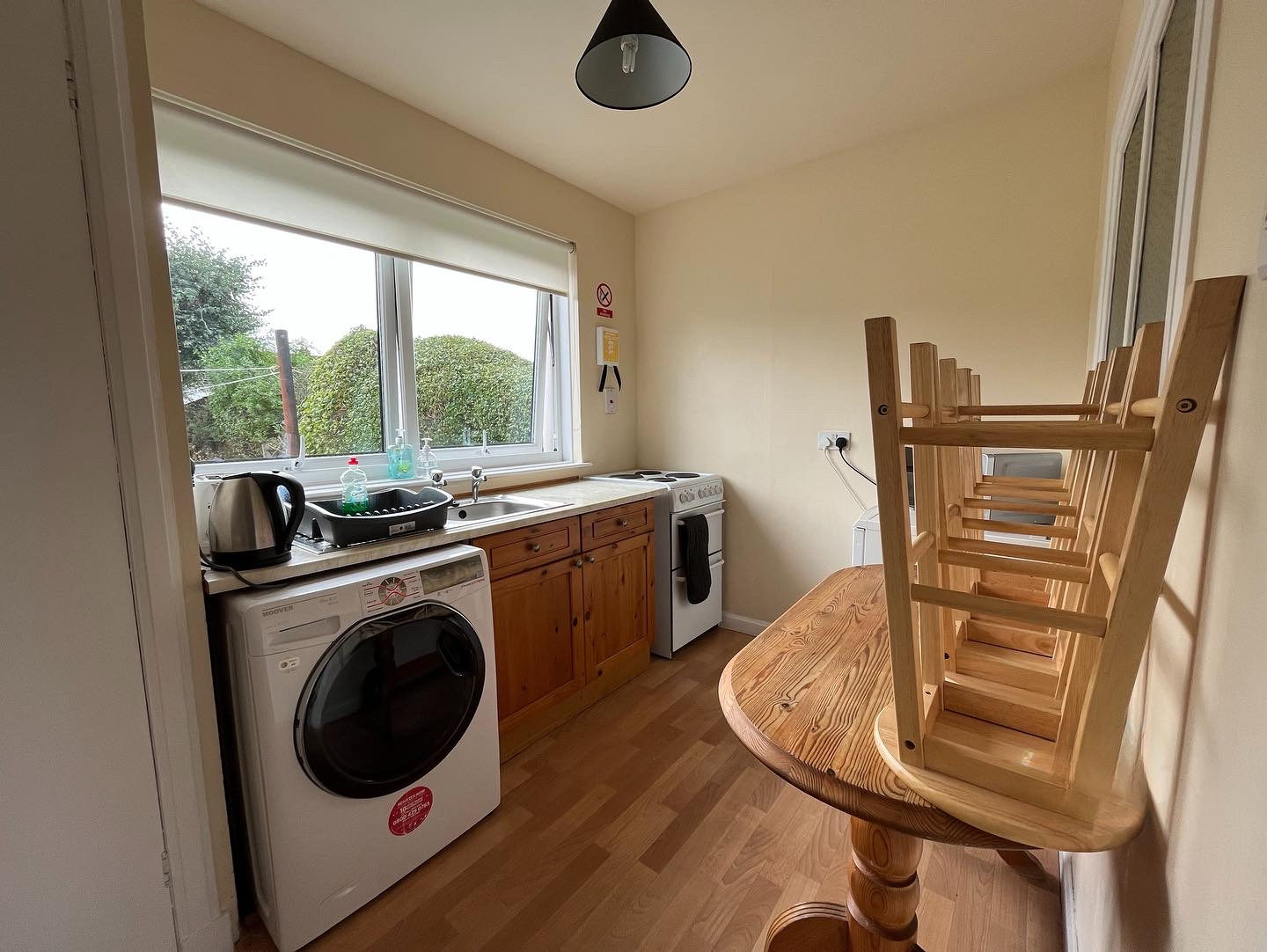 Fully-equipped kitchen in Inverness holiday cottage — oven, washing machine, dining area