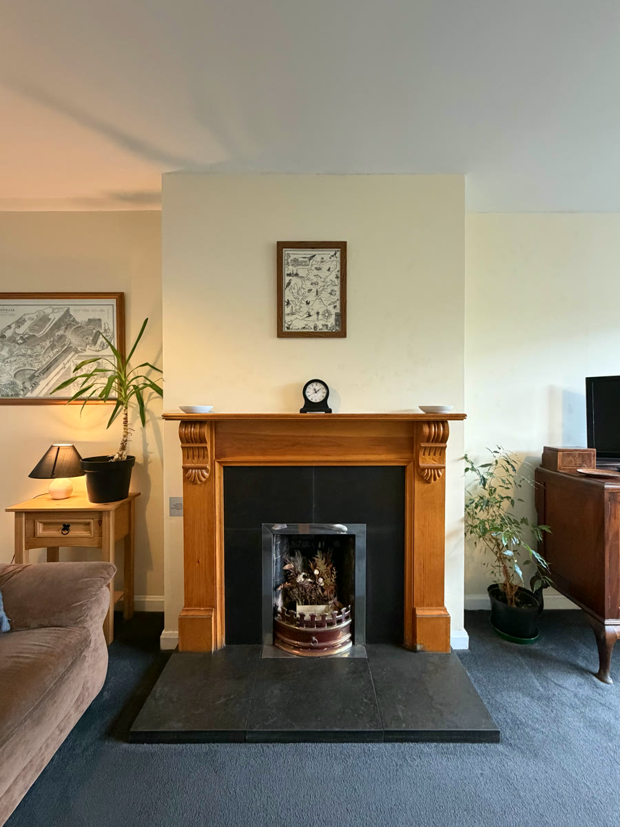 Living room fireplace with wooden surround in Inverness self-catering holiday home